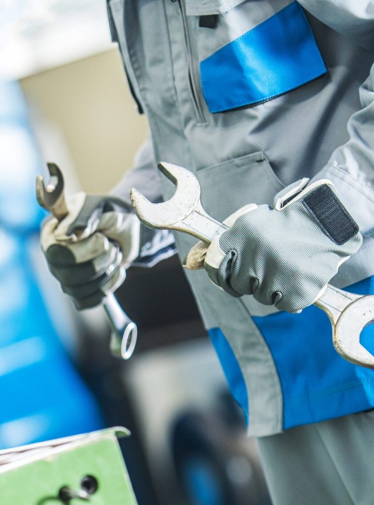 Technician with Two Large Wrenches is Going To Fix Lathe Machine. Metalworking Theme.